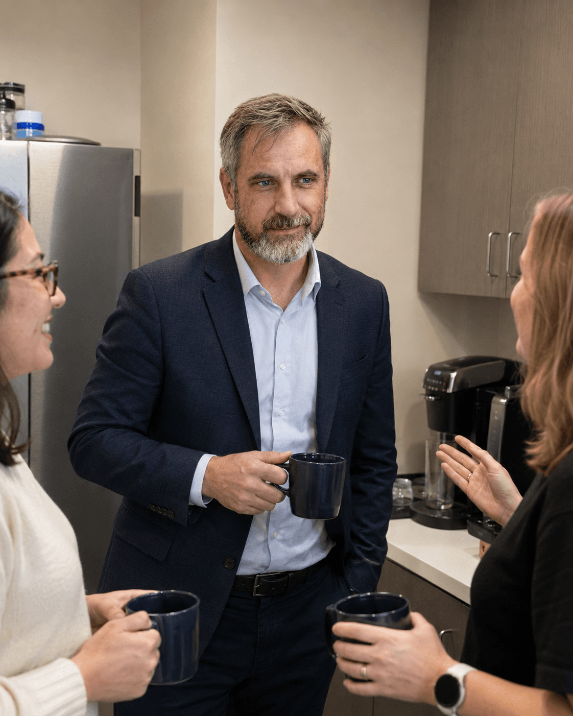 Agents talking over coffee in the TX Commercial Insurance office kitchen